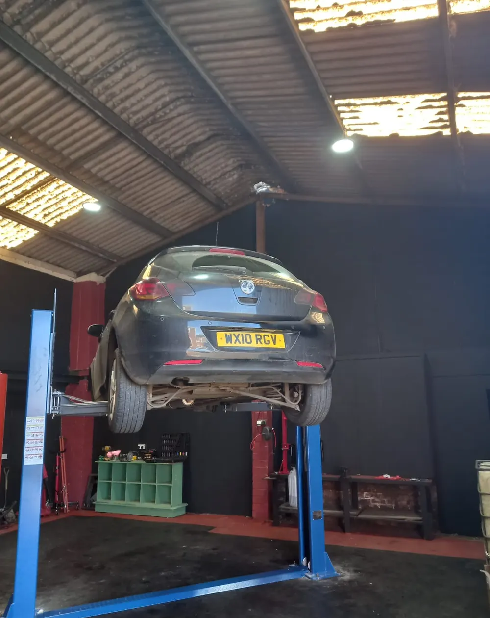 Vehicle raised on a lift inside the Apex Auto Service workshop