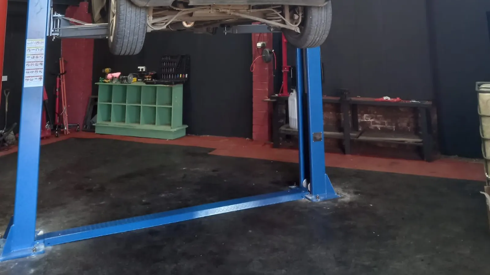 Vehicle on an Apex Auto Service workshop lift after a front brake rebuild, new pads and new tyres